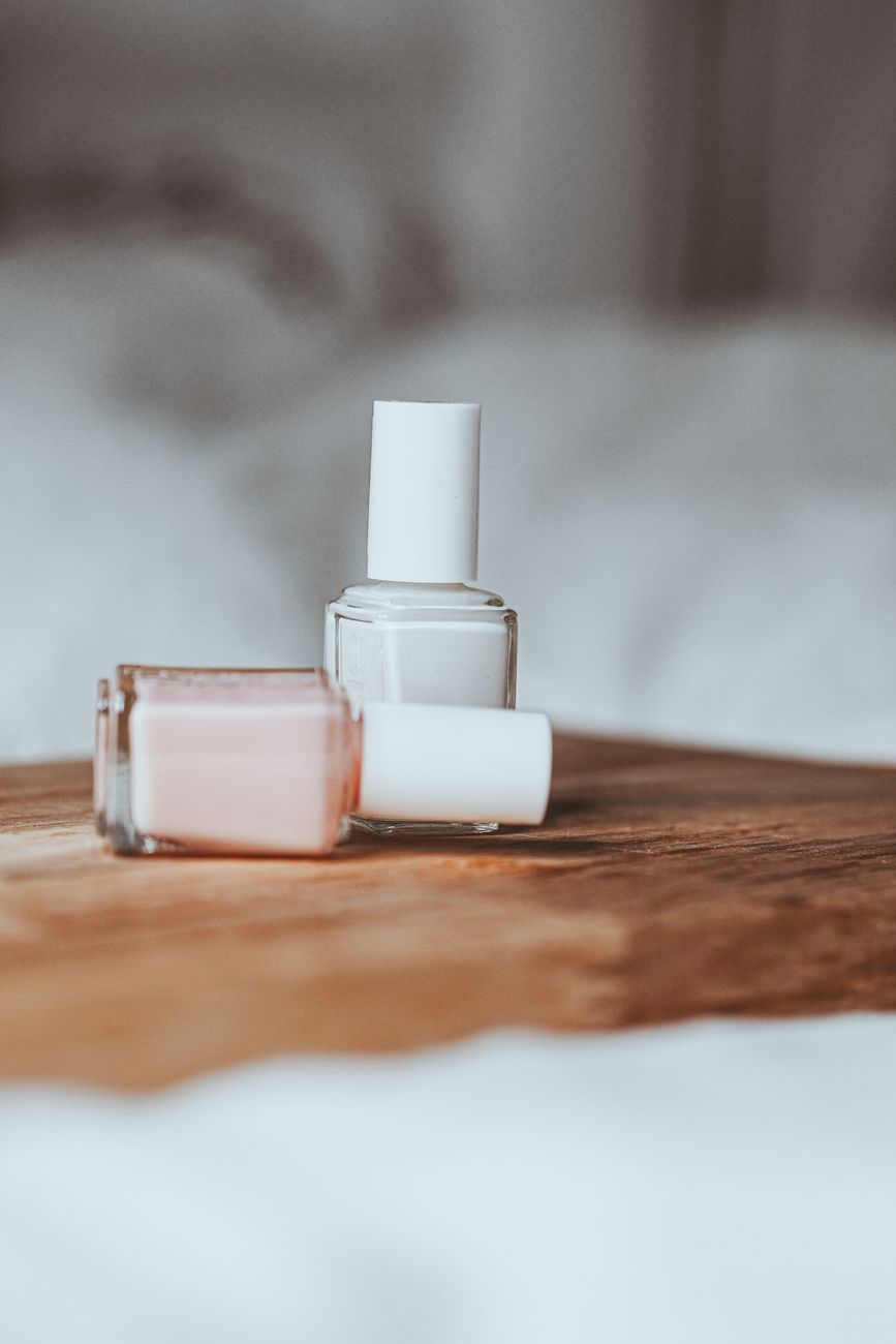 two small bottle on a wooden tray